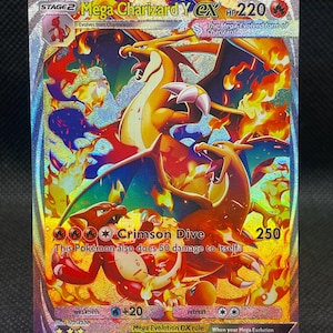 May include: A holographic Mega Charizard Y ex Pokémon trading card. The card features a fiery illustration of Charizard in various forms, with the text "Crimson Dive" and "HP 220". The card is held in a clear display stand.