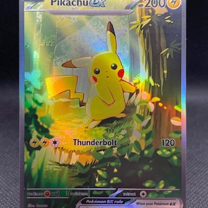 May include: A holographic Pikachu EX Pokémon trading card. The card features a yellow Pikachu character with red cheeks and brown-tipped ears. The card has the text "Thunderbolt" and "HP 200" on it. The background is a forest scene.