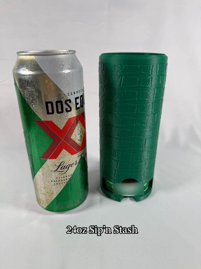 May include: A 24 fl oz Dos Equis Lager beer can next to a green, textured, cylindrical container. The can is silver, green, and red. The text "24oz Sip'n Stash" is at the bottom.