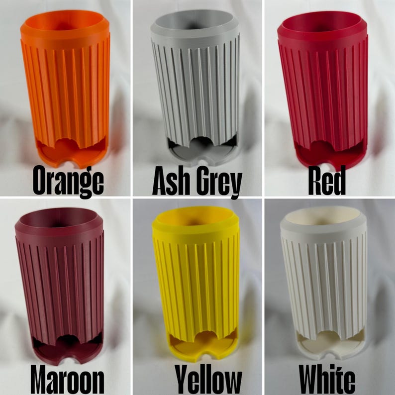May include: A collection of six cylindrical cup holders in various colors: orange, ash grey, red, maroon, yellow, and white. Each holder has vertical grooves and a unique base design. The colors are labeled below each cup holder.