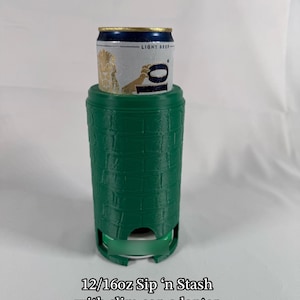 May include: A green 12/16oz Sip 'n Stash with a slim can adapter. The can holder has a textured brick pattern and is designed to hold a standard-sized beverage can. The can is silver with a gold and blue top and the words "LIGHT BEER".