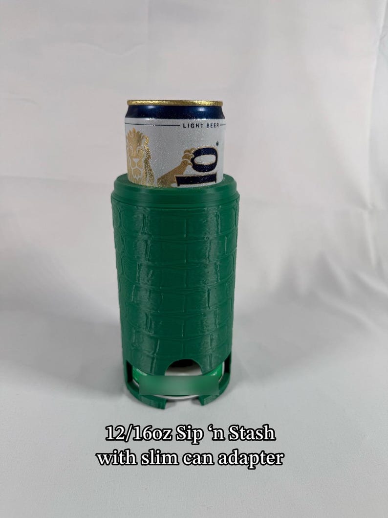 May include: A green 12/16oz Sip 'n Stash with a slim can adapter. The can holder has a textured brick pattern and is designed to hold a standard-sized beverage can. The can is silver with a gold and blue top and the words "LIGHT BEER".
