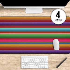 May include: A colorful striped mousepad with a mouse on top. The mousepad has a variety of colors, including red, orange, yellow, green, blue, purple, and brown. The mousepad is rectangular and has a black border. The mouse is white and has a black scroll wheel. The mousepad is available in 4 sizes.