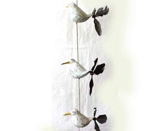 Wind chime with 3 wooden seagulls and feather propeller on the tail