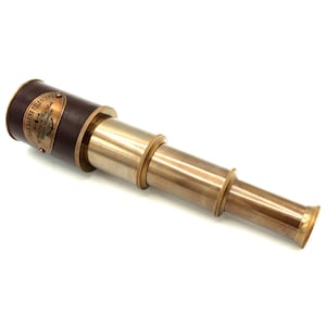 Puede incluir: Un telescopio de latón con un agarre de cuero marrón. El telescopio tiene un diseño clásico con secciones extensibles. El agarre de cuero presenta una placa de latón con el texto "Victorian Marine Telescope".