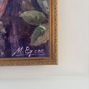 May include: Oil painting in a gold ornate frame. The artwork features a dark, moody color palette with visible brushstrokes. Green leaves and other foliage are visible. The artist's signature, "M. Eyner", is in the lower left corner.