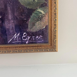 May include: An oil painting in a gold ornate frame. The artwork features dark purple and green brushstrokes, with the signature "M. Eyner" in white script. The frame has a detailed, textured design.