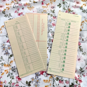 May include: Two blank time cards with green and red lines. The top card has the text "This Space is for Time Out or Lost Time" and the bottom card has the text "THIS SIDE OUT".