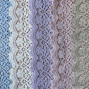 May include: Five different lace trims in various colors, including blue, white, purple, and green. The lace trims have a delicate floral pattern and are perfect for adding a touch of elegance to any project.