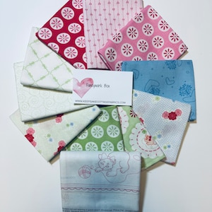 May include: A collection of 10 fabric squares with various patterns, including pink and white polka dots, green and white floral designs, and blue and white geometric patterns. The fabric squares are arranged in a circle around a card that reads "Fancywork Box" and "www.keepsakecottagefabrics.com".
