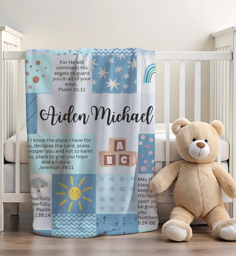 May include: A blue and white patchwork baby blanket with the names Aiden Michael and bible verses. The blanket features a sun, ABC blocks, and a rainbow.