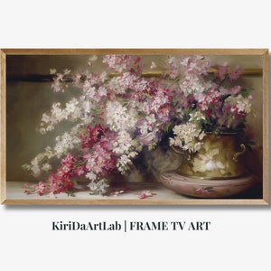 May include: A framed floral still life painting. The artwork features a brass pot filled with white and pink flowers. The pot sits on a pink dish, and the background is a muted green.