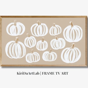Könnte beinhalten: Ein gerahmter Druck mit beigefarbenem Hintergrund und weißen Kürbissen mit goldenen Stielen. Der Text "KiriDaArtLab | FRAME TV ART" befindet sich unten auf dem Druck.