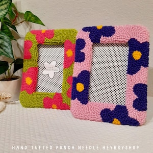 Set of handmade punch needle 4x6 picture frames featuring colorful daisy designs. Crafted with soft yarn, these frames add a cozy vibe to any space. Perfect for displaying cherished photos or as a unique decorative piece. Not wall-mounted.