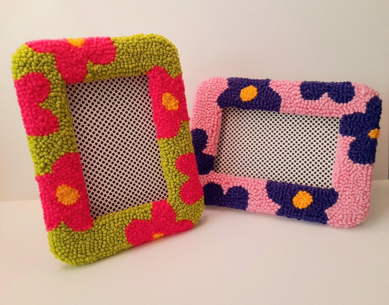 Set of handmade punch needle 4x6 picture frames featuring colorful daisy designs. Crafted with soft yarn, these frames add a cozy vibe to any space. Perfect for displaying cherished photos or as a unique decorative piece. Not wall-mounted.