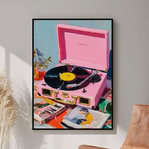 May include: A framed painting of a pink record player with a black vinyl record. The record player is open, and the needle is on the record. Two album covers and a cassette tape are in front of the record player. The background is blue.