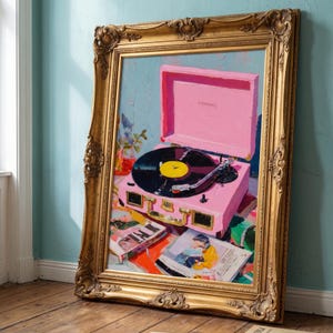 May include: An oil painting in an ornate gold frame depicting a bright pink portable record player with a black vinyl record on the platter. The turntable sits on a surface covered with colourful books and magazines, rendered in a painterly style.