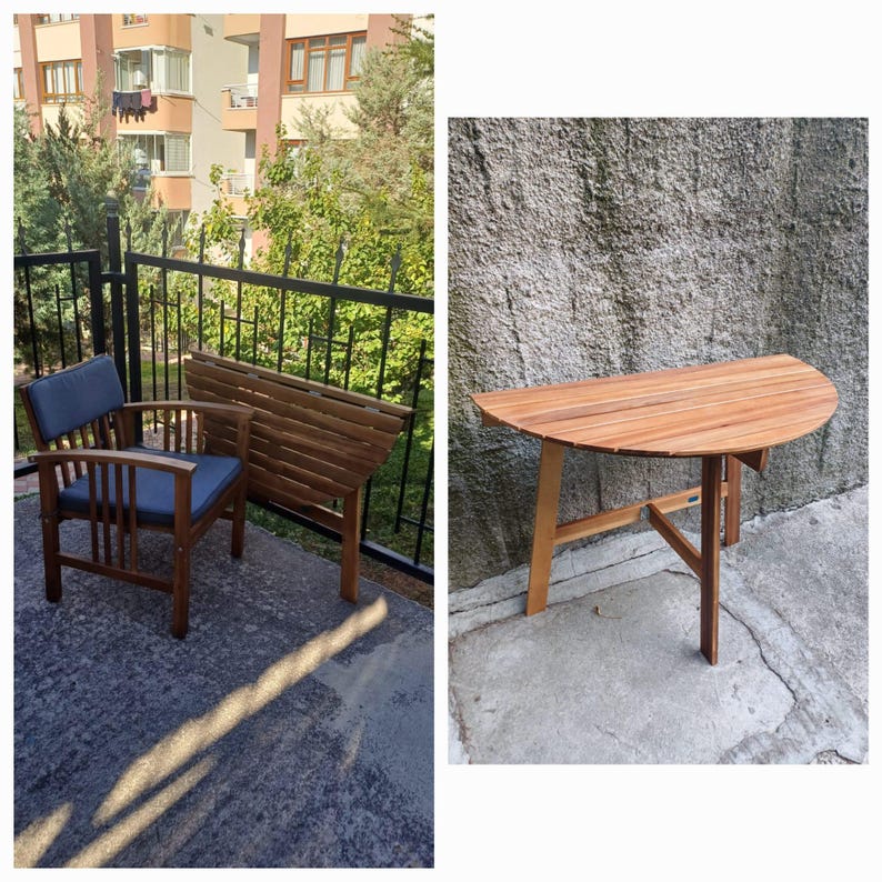 May include: A wooden folding table with a half-circle top and a wooden chair with a blue cushion. The table and chair are on a patio with a black metal railing.