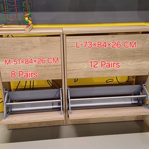 May include: Two wooden shoe storage cabinets with pull-out shelves. The cabinet on the left is labeled "M-51x84x26 CM 8 Pairs" and the cabinet on the right is labeled "L-73x84x26 CM 12 Pairs".