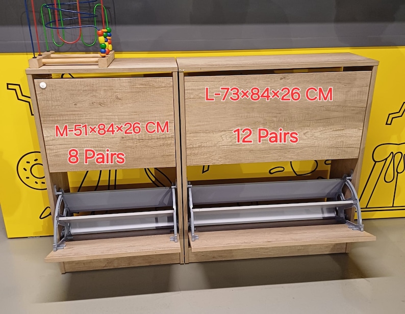 May include: Two wooden shoe storage cabinets with pull-out shelves. The cabinet on the left is labeled "M-51x84x26 CM 8 Pairs" and the cabinet on the right is labeled "L-73x84x26 CM 12 Pairs".