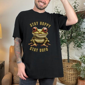 May include: Black t-shirt with a cartoon frog and the text "Stay Hoppy Stay Bufo".
