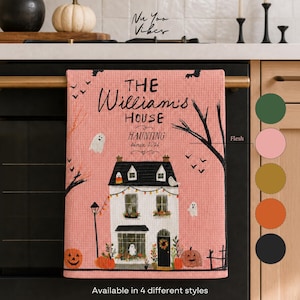 May include: A pink waffle-weave kitchen towel featuring a black and white house illustration, ghosts, pumpkins, and bats. The text reads THE William's HOUSE HAUNTING since 2024. A vertical color palette shows green, pink, gold, orange, and black circles.