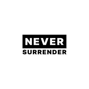 May include: A white sticker with the words "NEVER SURRENDER" in bold, black capital letters. The text is arranged in two lines, with "NEVER" above "SURRENDER". The text is set against a black rectangular background.