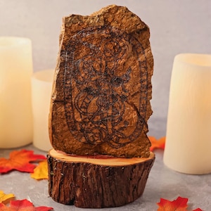 Viking age runestone cut in stone and mounted in cedar cross-section
