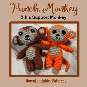 Könnte beinhalten: Zwei gehäkelte Affenpuppen, eine braune und eine orangefarbene, mit grauen Gesichtern und Bäuchen. Der Text "Punch Monkey & his Support Monkey" steht oben und "Downloadable Patterns" unten.