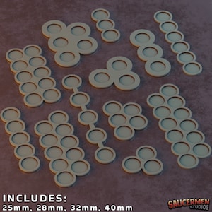 May include: A collection of beige, circular game bases in various configurations. The bases are designed with recessed areas and are available in 25mm, 28mm, 32mm, and 40mm sizes. The image includes the text "INCLUDES: 25mm, 28mm, 32mm, 40mm".