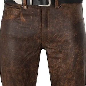 May include: Brown leather pants with a distressed look. The pants have a straight leg and a classic five-pocket design.