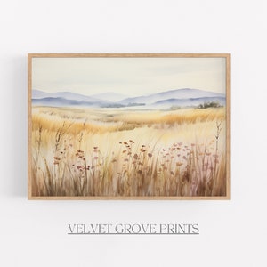 May include: A watercolour painting depicting a field of tall grass with a distant mountain range in the background. The grass is a light brown colour and the mountains are a light blue colour. There are small pink flowers scattered throughout the field.