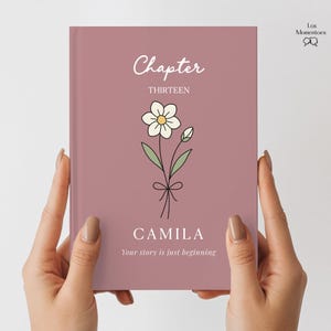 May include: A mauve-colored book cover with the word "Chapter" in white script above "THIRTEEN". A daisy illustration is centered below the text, with the name "CAMILA" and the phrase "Your story is just beginning" below. The book is held by two hands.