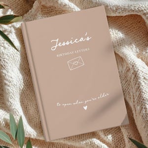 May include: A white ceramic mug with a black handle and the text "But First, Coffee" in a handwritten style. The mug is on a white surface. The mug is likely for hot beverages.