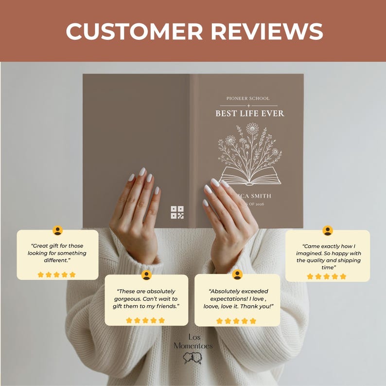 May include: A book cover with the text "PIONEER SCHOOL BEST LIFE EVER" and floral illustrations. The cover is held by a person. Customer reviews are displayed below the book, with phrases like "Great gift" and "Absolutely exceeded expectations!"