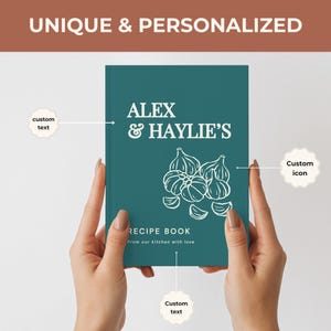May include: A teal hardcover recipe book featuring white text that reads ALEX & HAYLIE'S, RECIPE BOOK, and From our kitchen with love. The cover includes a white line-art illustration of garlic bulbs and cloves, with labels indicating custom text and icon.