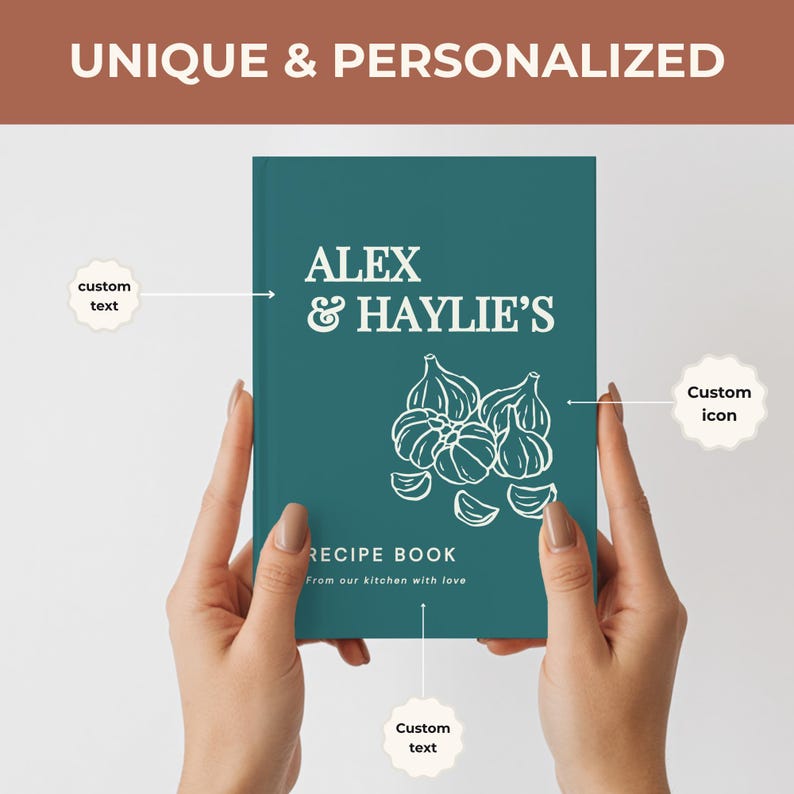 May include: A teal hardcover recipe book featuring white text that reads ALEX & HAYLIE'S, RECIPE BOOK, and From our kitchen with love. The cover includes a white line-art illustration of garlic bulbs and cloves, with labels indicating custom text and icon.
