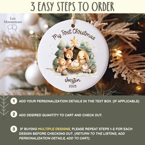 May include: A white ceramic Christmas ornament with a watercolor illustration of a nativity scene. The ornament has the text "My First Christmas", a name, and the year 2025. The ornament hangs from a natural twine string.