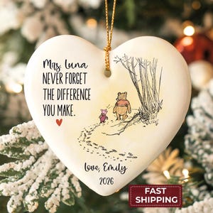 May include: Heart-shaped ceramic ornament with a Winnie the Pooh illustration. The ornament has the text "Mrs. Luna, Never Forget The Difference You Make" and "Love, Emily 2026". A red heart is also included.
