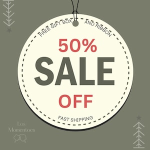May include: A white circle with a black border and a dashed line pattern. The circle has the text "FREE GIFT BOX AND RIBBON" at the top, "50% SALE OFF" in the center, and "FAST SHIPPING" at the bottom. The background is a solid green color.