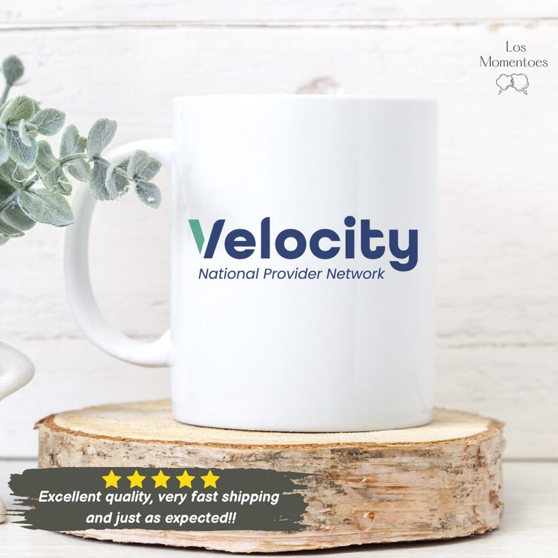 May include: White ceramic mug featuring the word "Velocity" in blue and green, and "National Provider Network" below. The mug is placed on a wooden slice. The text "Excellent quality, very fast shipping and just as expected!!" is at the bottom.