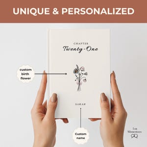 May include: A personalized cream-colored book cover with the text "Chapter Twenty-One" and a floral illustration. The book is labeled "Unique & Personalized" at the top. The name "Sarah" is printed below the floral design. The words "custom birth flower" and "custom name" are also present.