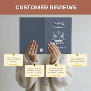 May include: A blue journal with the text "JAME'S CAMP MEMORIES" and a line drawing of a canoe on a lake. The journal is held by a person. Customer reviews are displayed in the image.