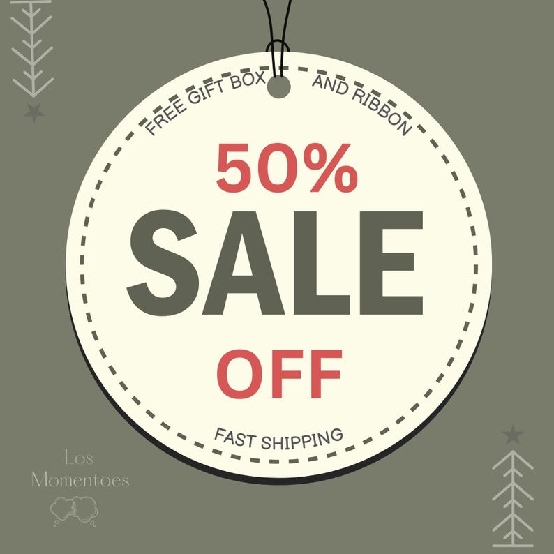 May include: A round cream-colored tag with a black string, displaying a 50% SALE OFF promotion. The text "FREE GIFT BOX AND RIBBON" and "FAST SHIPPING" are also present. The background is a muted green.