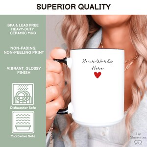 May include: White ceramic mug with black handle and rim, featuring the text "Your Words Here" and a red heart. The mug is labeled as BPA & lead-free, heavy-duty, and dishwasher and microwave safe. The mug has a vibrant, glossy finish.