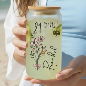 21st birthday glass with the number 21 and says cocktail legal colored birthflower personalized with name February birth flower shown Iris on frosted glass tumbler