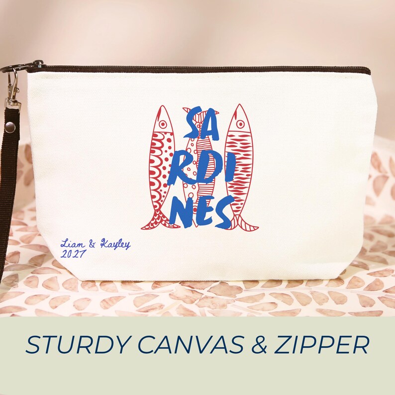 Sardines Mediterranean sailorcore personalized Zipper close canvas sardines makeup bag pencil pouch with bold blue and red sardine print and optional personalized name in script on cream coastal fabric. Sailorcore sardinecore and Mediterranean market girl aesthetic perfect for storing makeup pens and travel essentials and designed to coordinate with the large coastal sardines tote bag sold separately.