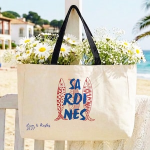 Sardines sailorcore Mediterranean Large zipper close canvas sardines tote bag for women with interior zipper pocket featuring bold blue and red sardine artwork and personalized name in script on cream coastal canvas. Sailorcore and sardinecore Mediterranean market bag style perfect as a coastal tote bag Italian summer beach bag and seaside gift with optional matching pencil pouch sold separately.
