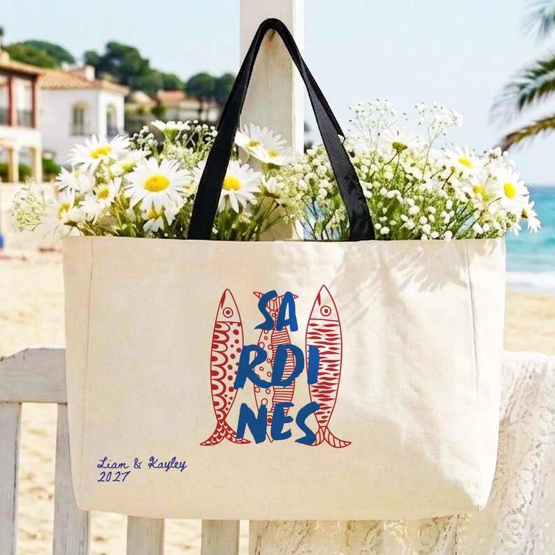 Sardines sailorcore Mediterranean Large zipper close canvas sardines tote bag for women with interior zipper pocket featuring bold blue and red sardine artwork and personalized name in script on cream coastal canvas. Sailorcore and sardinecore Mediterranean market bag style perfect as a coastal tote bag Italian summer beach bag and seaside gift with optional matching pencil pouch sold separately.