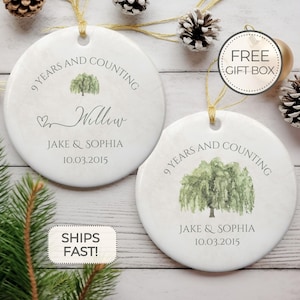 May include: Two white round ceramic ornaments with a willow tree design. The ornaments are personalized with the text "9 years and counting", "Willow", "Jake & Sophia", and "10.03.2015".